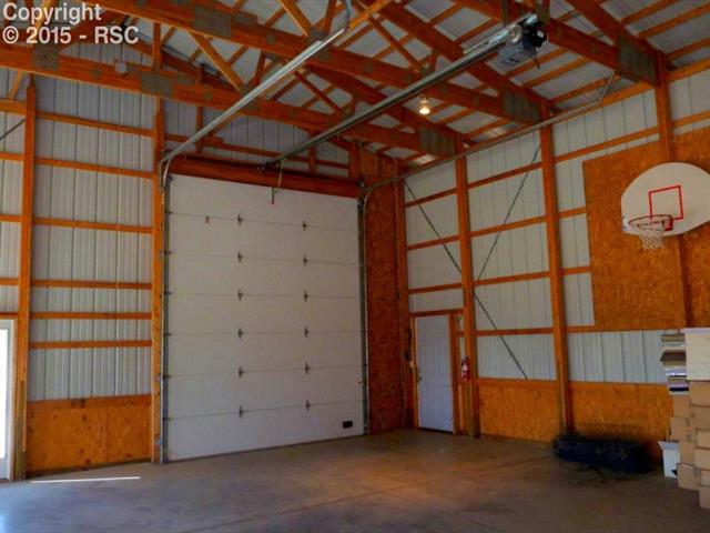 1095 Doe Valley Road Guffey, CO 80820 - Photo 8 of 21 The NW corner of the building. In addition to the overhead door there are service doors on 3 sides.