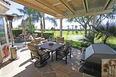 80555 Knightswood Road Indio, CA 92201 - Photo 23 of 25 a view of a patio with table and chairs potted plants with large tree