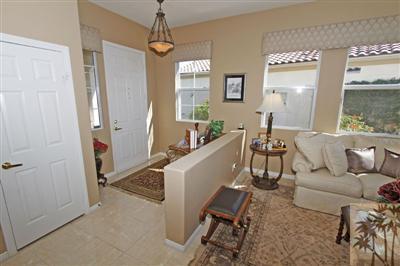 80555 Knightswood Road Indio, CA 92201 - Photo 4 of 25 a living room with furniture and a chandelier