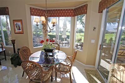 80555 Knightswood Road Indio, CA 92201 - Photo 10 of 25 a dining room with furniture a chandelier and glass door
