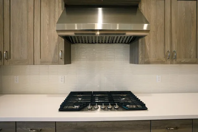 a close view of a stove a microwave and door