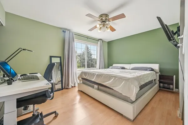 a bedroom with a bed and a chandelier