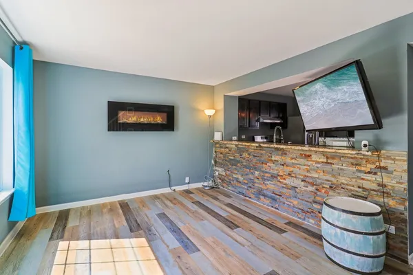 a living room with hard wood flooring and a couch