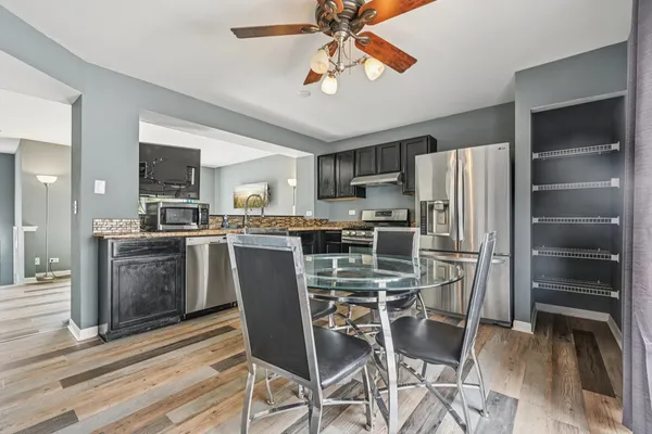 a kitchen with stainless steel appliances a refrigerator a stove top oven and kitchen island