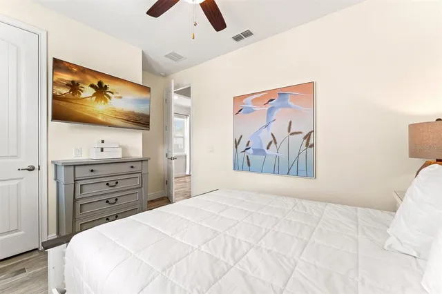 a bedroom with a bed and ceiling fan