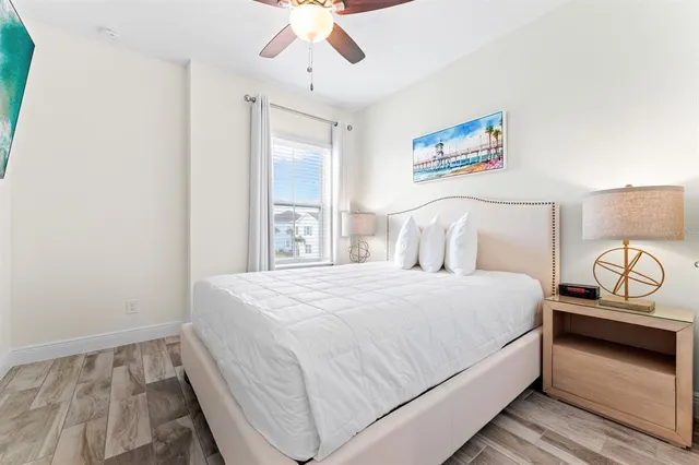 a bedroom with a bed and a painting on the wall