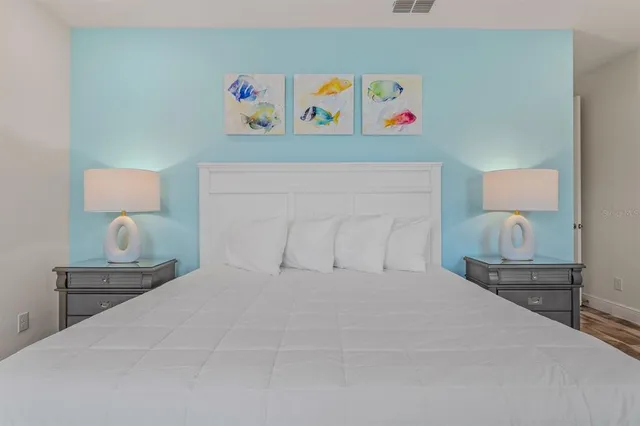 a front view of a house with a yard and potted plants