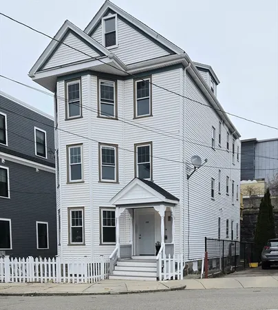 a view of a white building with large windows