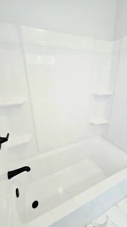 an empty room with wooden floor chandelier fan and windows