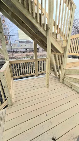 a view of a closet with wooden floor