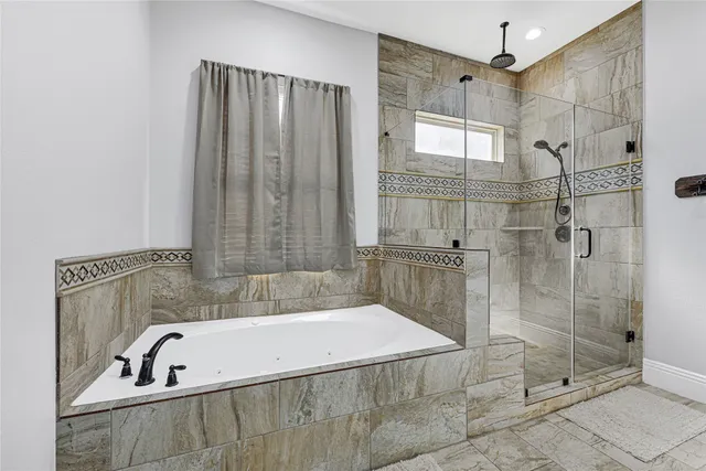 a bathroom with a tub and a shower