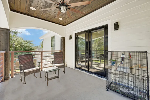a porch with a bench next to a yard