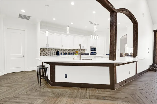a view of kitchen with stainless steel appliances granite countertop a sink and stove