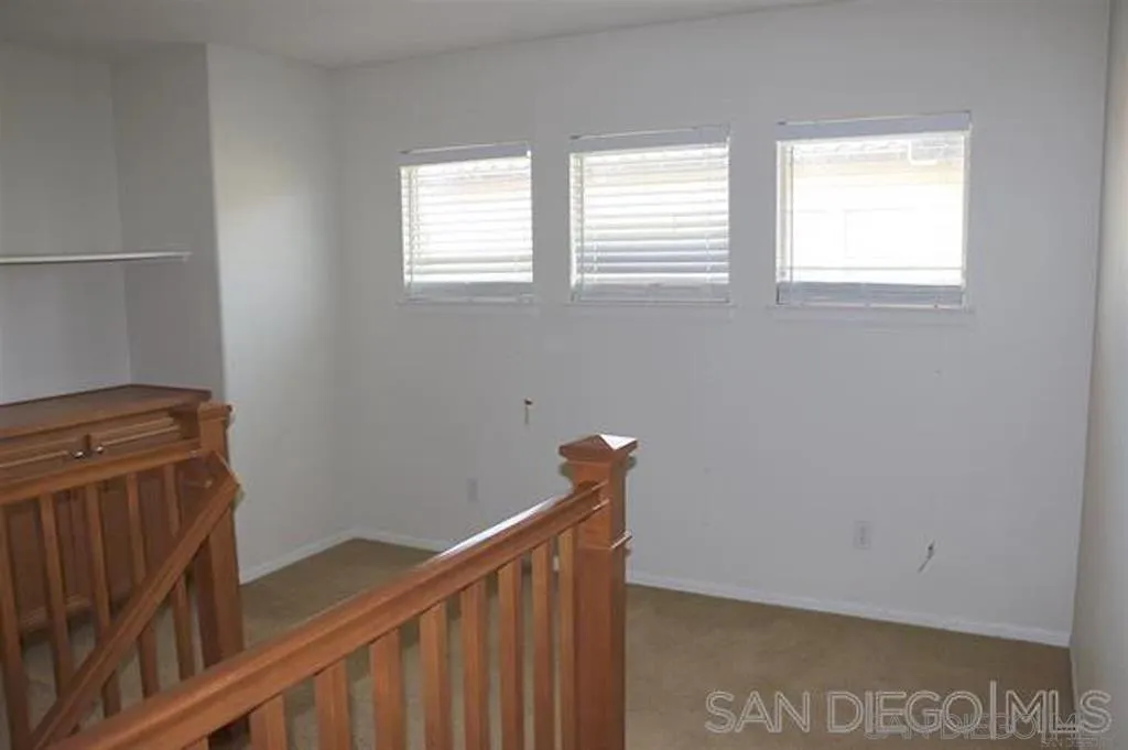 1586 Hopscotch Drive Chula Vista, CA 91915 - Photo 6 of 7 a view of a hallway with wooden stairs