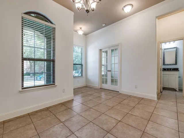 a view of an empty room with window and cabinet