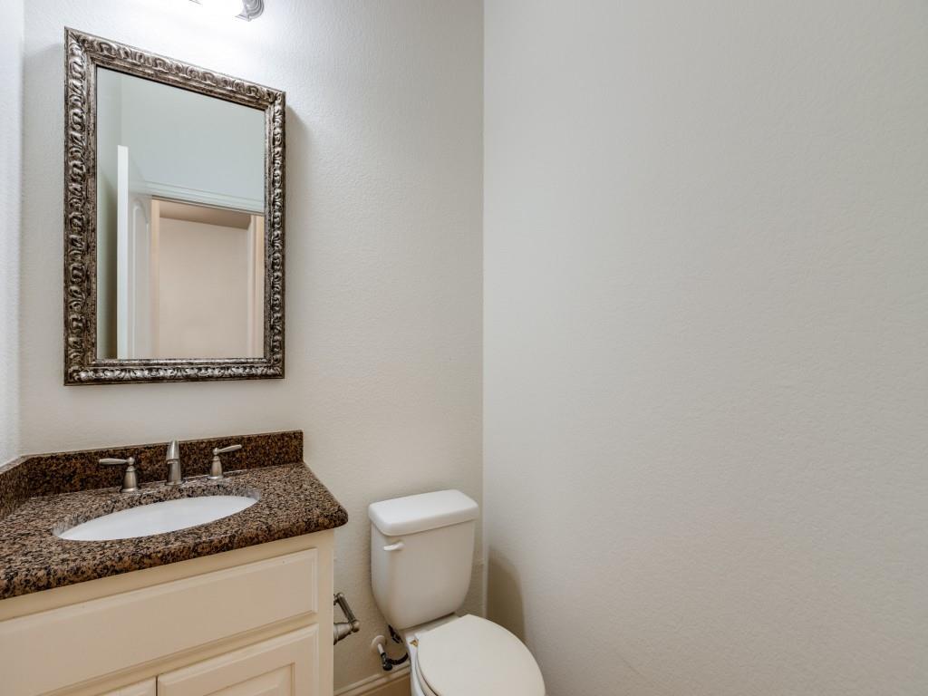 4696 Cecile Road Plano, TX 75024 - Photo 17 of 26 a bathroom with a granite countertop sink and a mirror