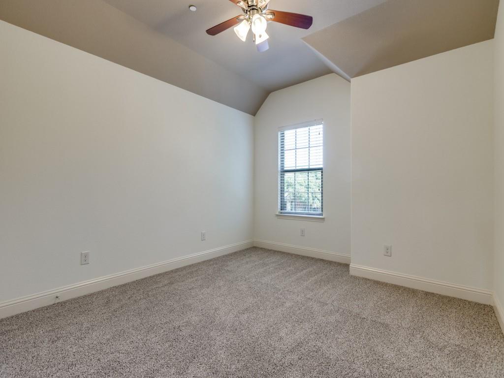 4696 Cecile Road Plano, TX 75024 - Photo 21 of 26 an empty room with a chandelier fan and windows