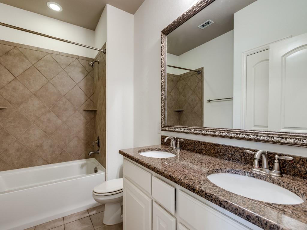 4696 Cecile Road Plano, TX 75024 - Photo 22 of 26 a bathroom with a granite countertop sink toilet and shower