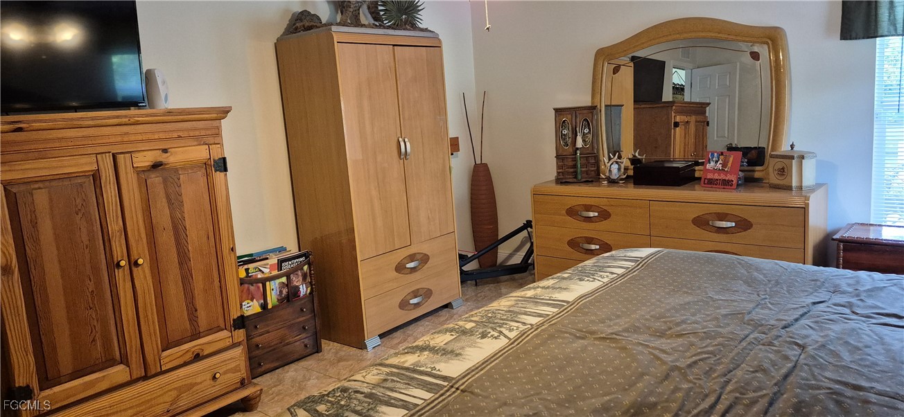 2011 Leroy Avenue Alva, FL 33920 - Photo 16 of 28 a spacious bedroom with a bed and mirror