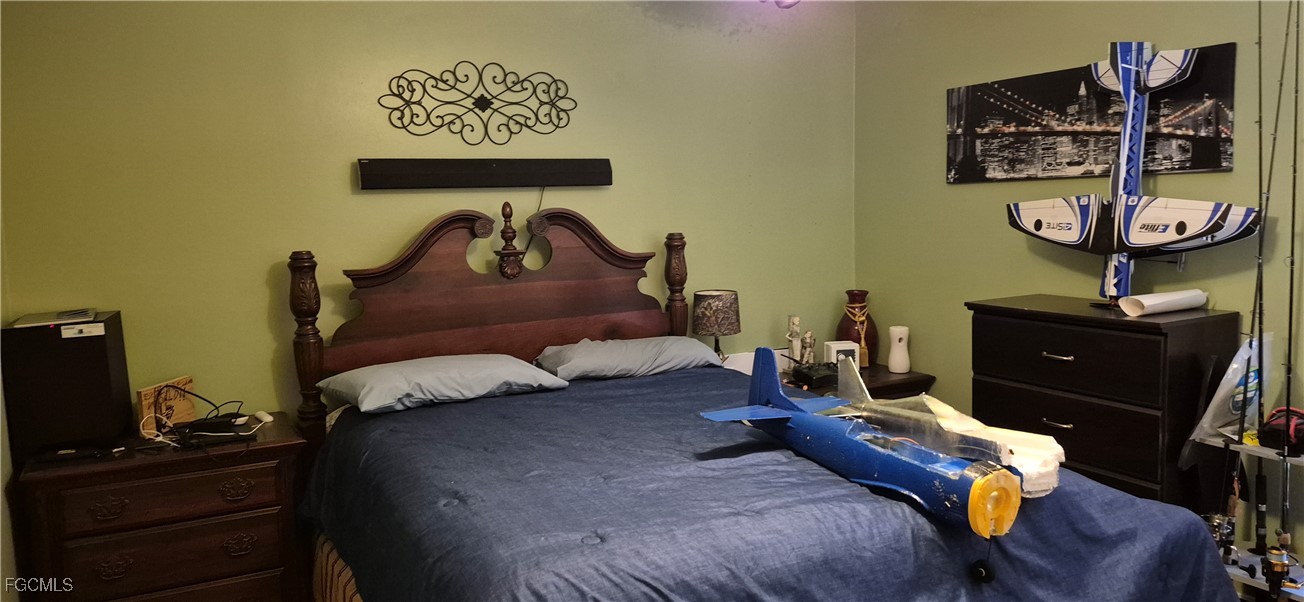 2011 Leroy Avenue Alva, FL 33920 - Photo 10 of 28 a bedroom with a bed and wooden floor