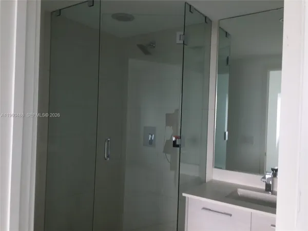 a bathroom with a shower and a sink