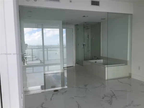 a bathroom with a bathtub and shower