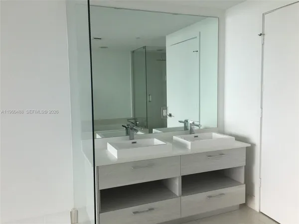 a bathroom with a double vanity sink and mirror