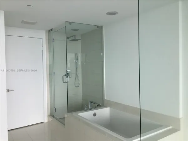 a bathroom with a bath tub and shower