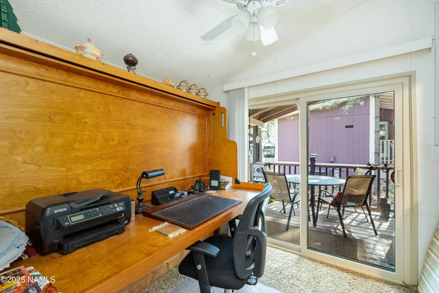 a view of a workspace with furniture