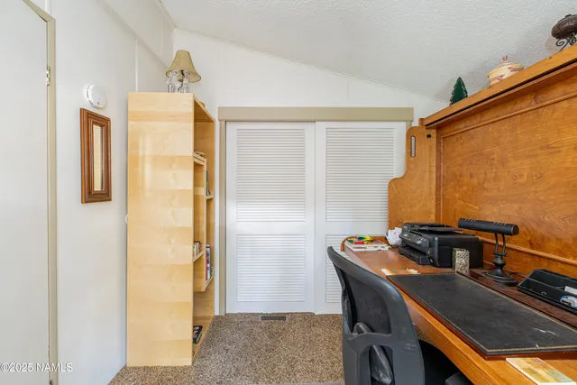 a bedroom with a bed and a table