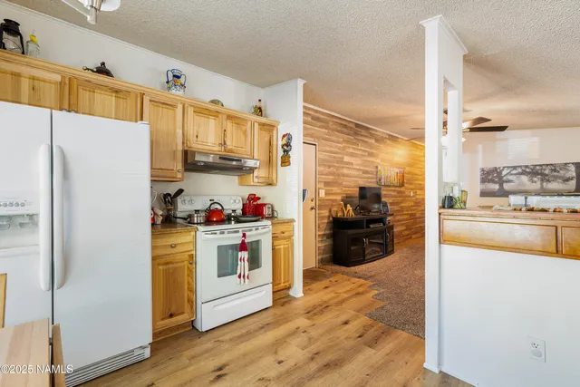 a kitchen with a refrigerator a stove top oven a sink and dishwasher