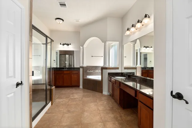 a large kitchen with a stove and a refrigerator