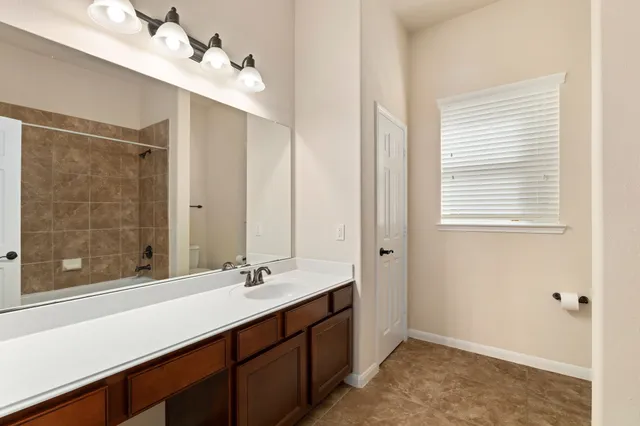 a white bath tub sitting next to a white sink