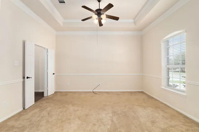 a view of a livingroom with a ceiling fan and window
