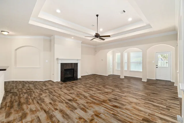 a view of an empty room with a fireplace and a window