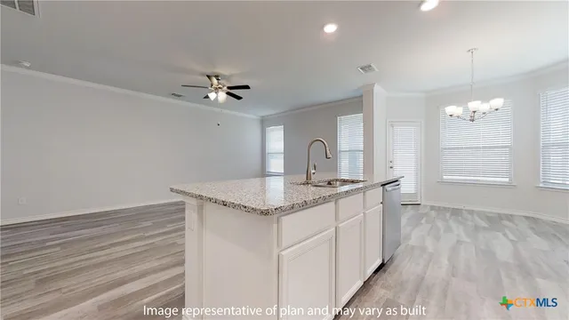 a kitchen with stainless steel appliances granite countertop a sink and a stove top oven
