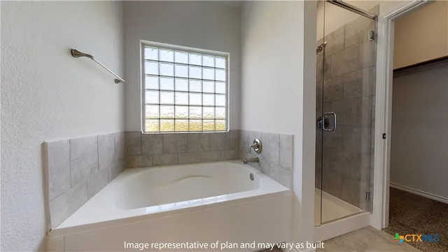 a bathroom with a granite countertop sink a mirror and shower