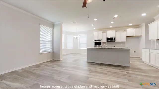 a view of kitchen with cabinets and wooden floor