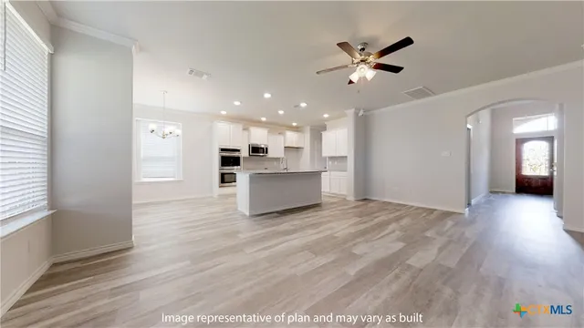 a view of kitchen with sink microwave and refrigerator