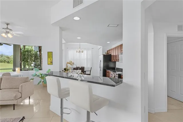 a kitchen with stainless steel appliances a refrigerator and a stove top oven