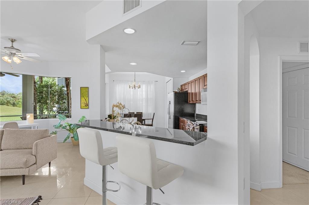 20240 Burnside Place, Unit 1603 Estero, FL 33928 - Photo 11 of 41 a dining room with furniture and a large window