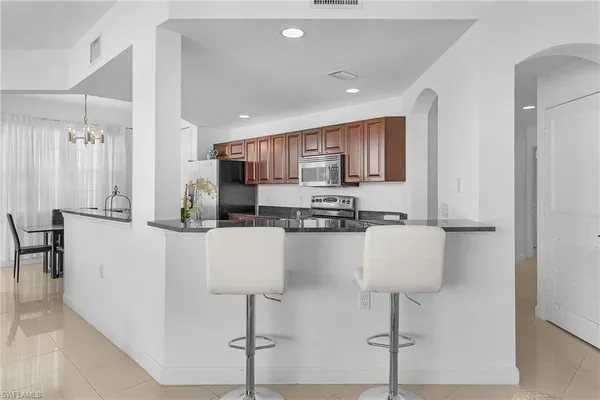 a kitchen with stainless steel appliances a sink and a refrigerator