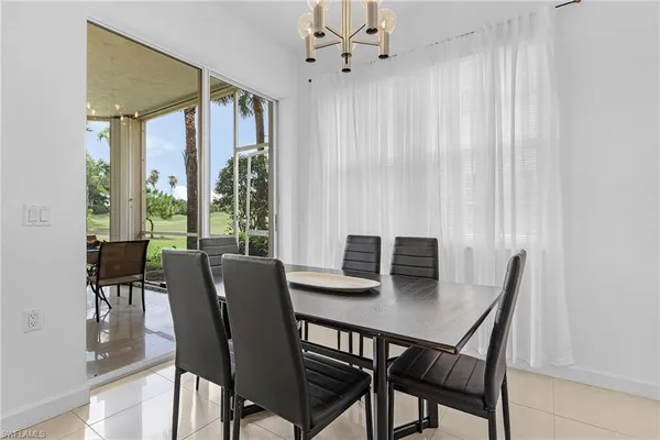 a view of a dining room with a table and chairs
