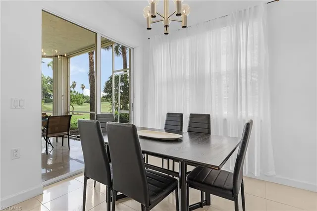 a view of a dining room with a table and chairs