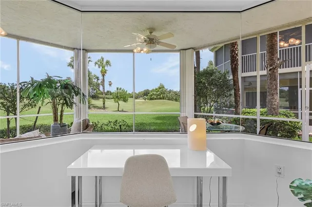 a bedroom with a bed table and window