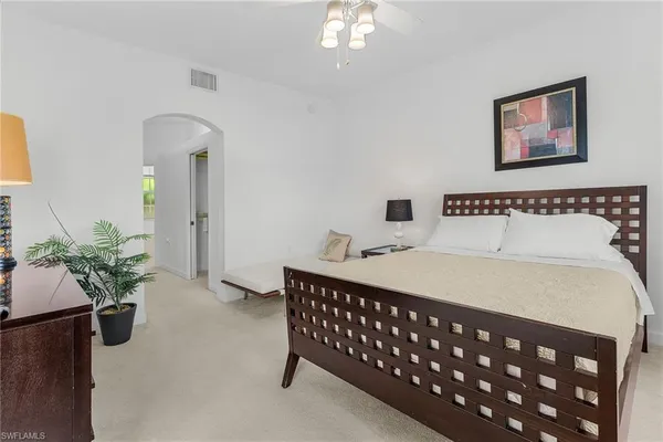 a bedroom with a bed and a table