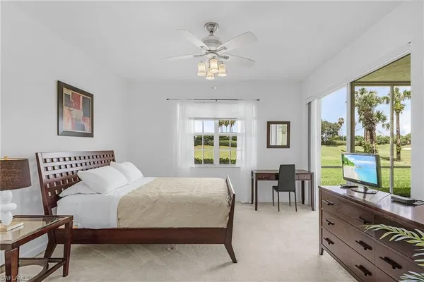 a bedroom with a bed flowerpot and window