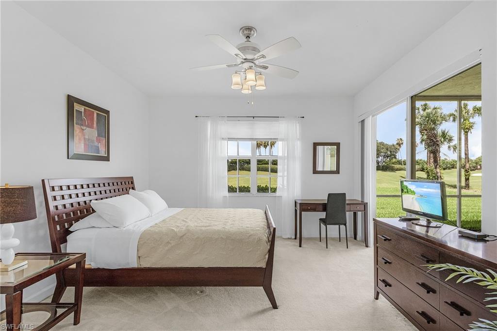 20240 Burnside Place, Unit 1603 Estero, FL 33928 - Photo 20 of 41 a bedroom with a bed and a table