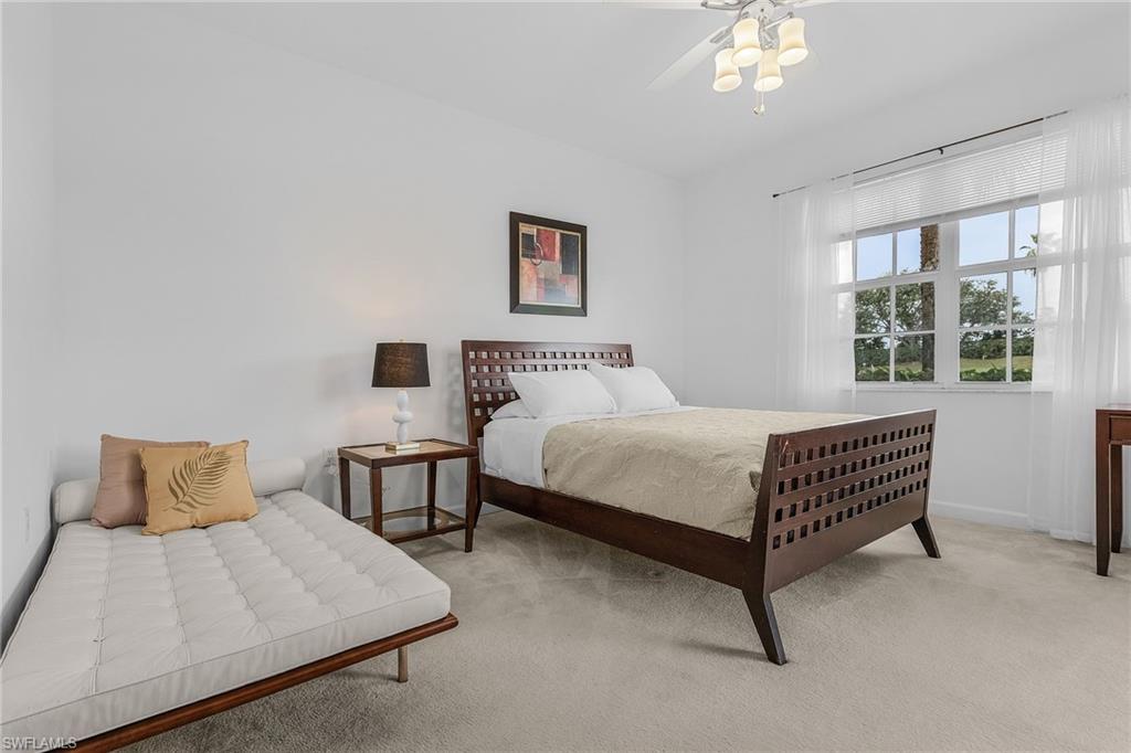 20240 Burnside Place, Unit 1603 Estero, FL 33928 - Photo 21 of 41 a bedroom with a bed flowerpot and window