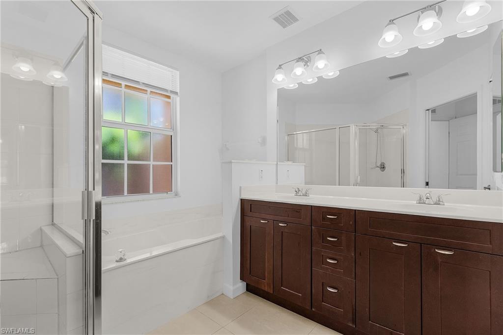 20240 Burnside Place, Unit 1603 Estero, FL 33928 - Photo 22 of 41 a bathroom with a sink vanity and mirror